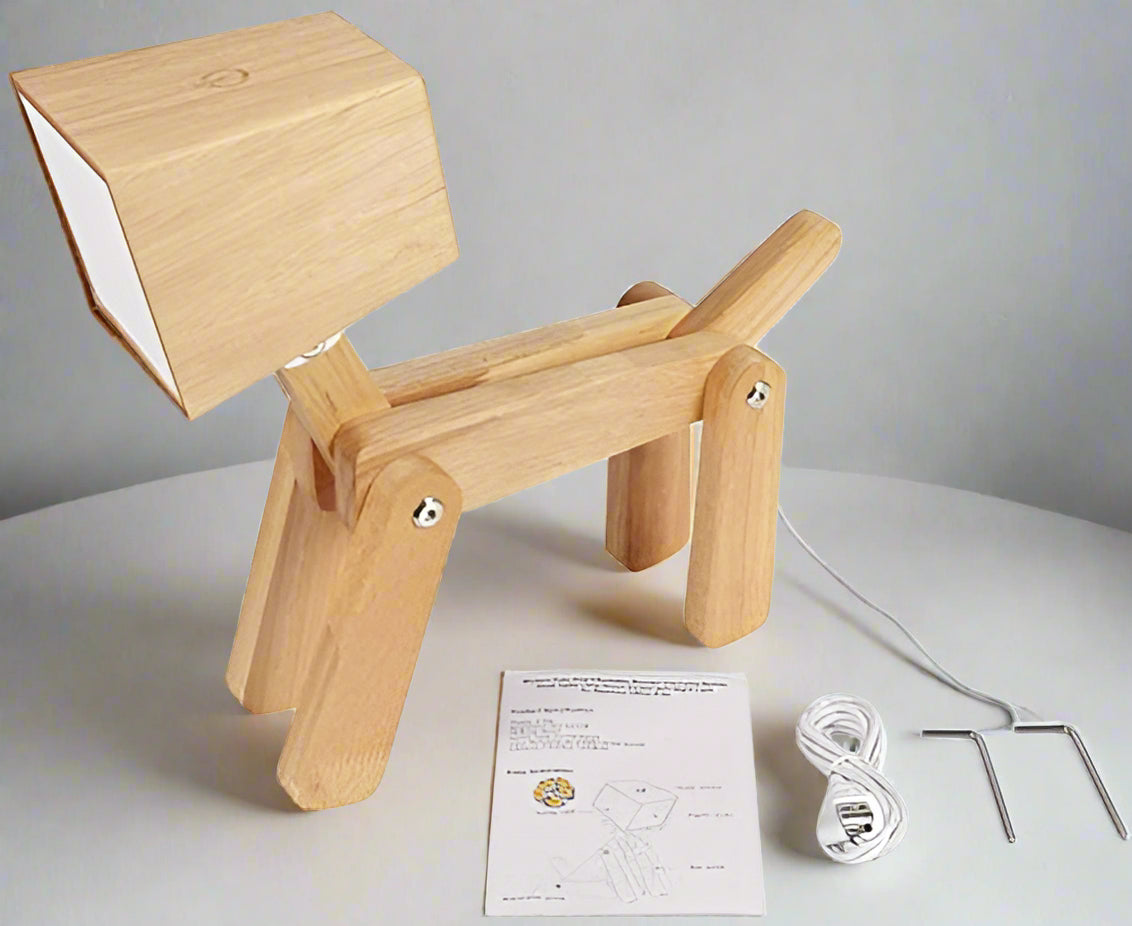 Wooden dog-shaped lamp with packaging and accessories on a white background